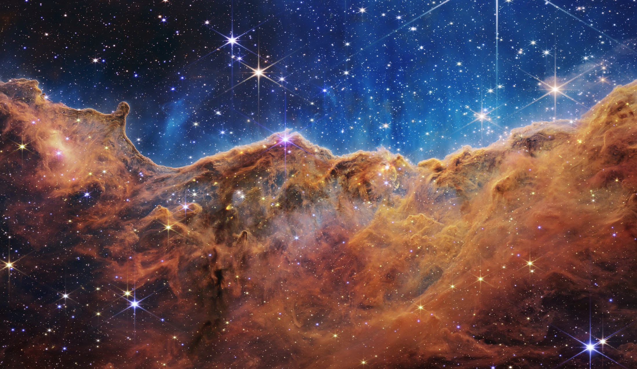 Astronomische afbeelding van de Cosmic Cliffs met toegewezen kleuren voor verschillende waarnemingsbanden